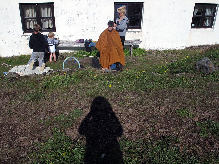 Djúpavík. The yearly visit at the haircutter (in Djúpavík). - Open Air hair cutting. By Kidda. (This picture was taken by Álfheiður!). (9 August 2011)